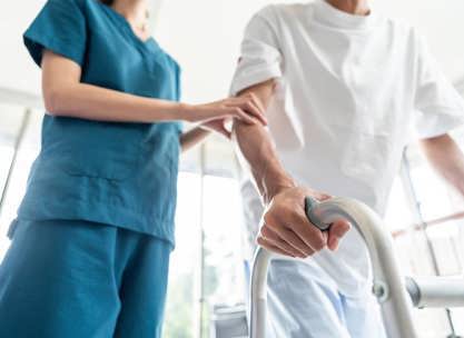 A healthcare professional assisting a patient with mobility assessment while Preparing for Inpatient Rehabilitation.